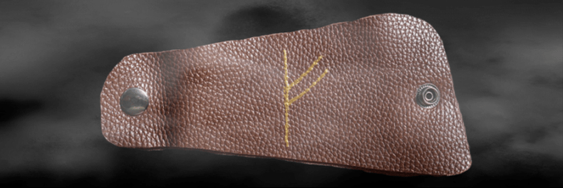 Fehu rune ant odos kaip sėkmės amuletas